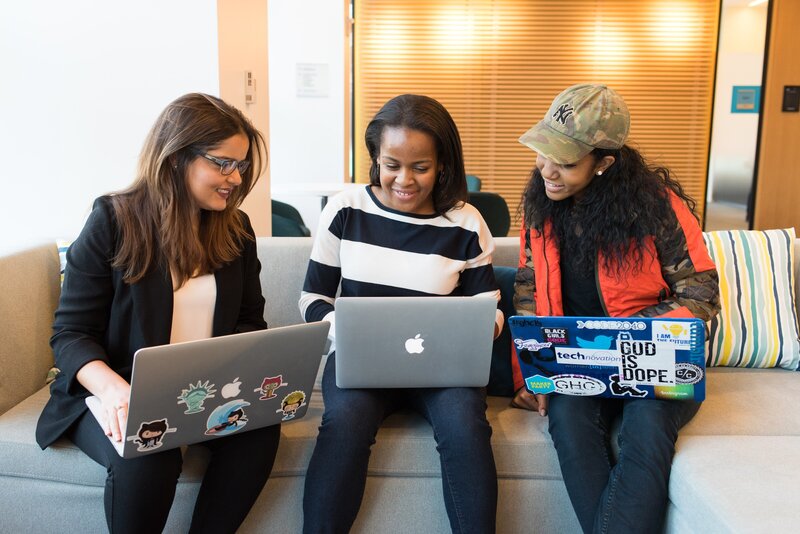 three diverse women working on laptops