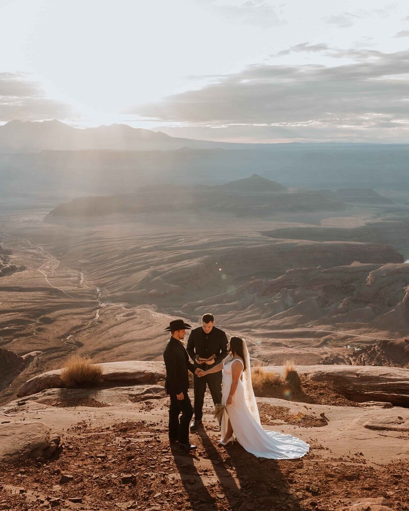 groom holding bride's hands