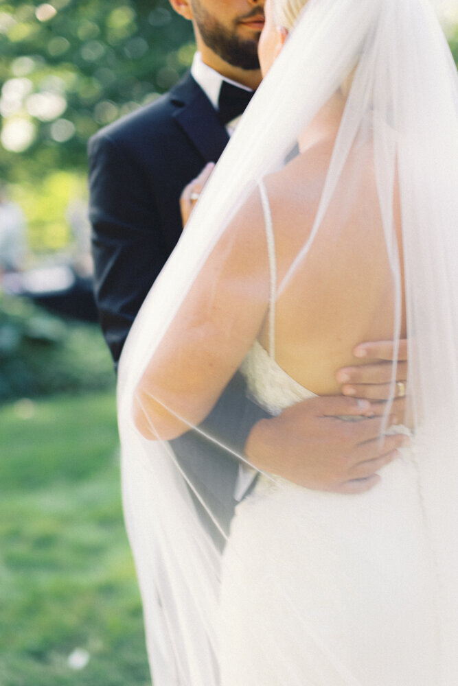 close up of bride and groom holding each other