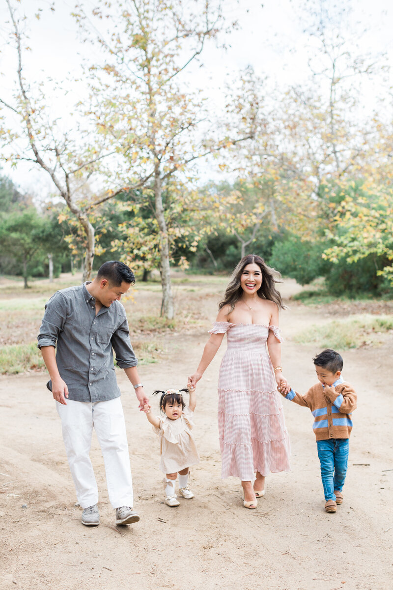 A family walking during their fall session in Denver, Colorado