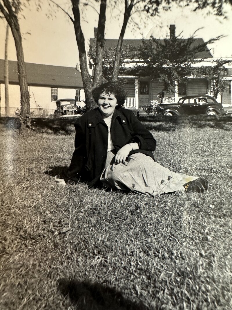 Black and white photograph of Barb Drummond's mother Sybil sitting on grass.