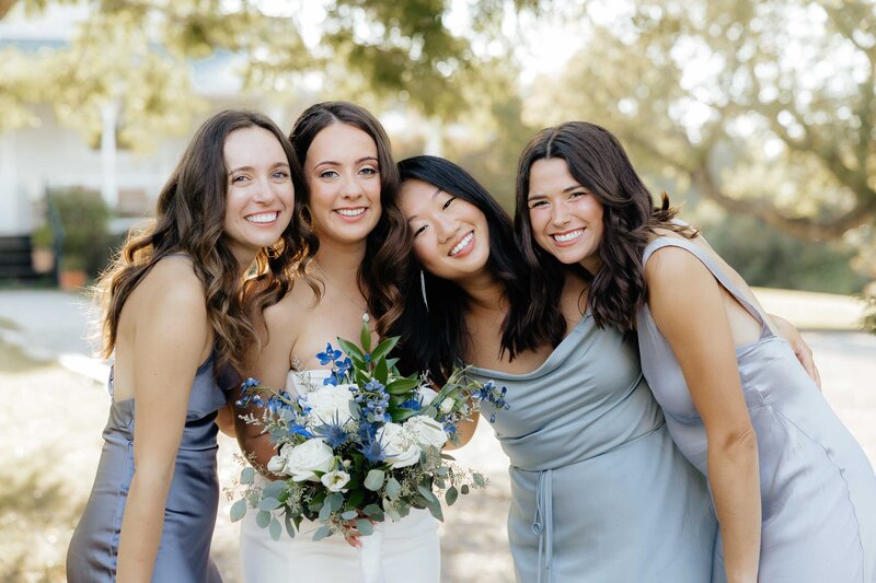 bridesmaids in dusty rose dresses smiling