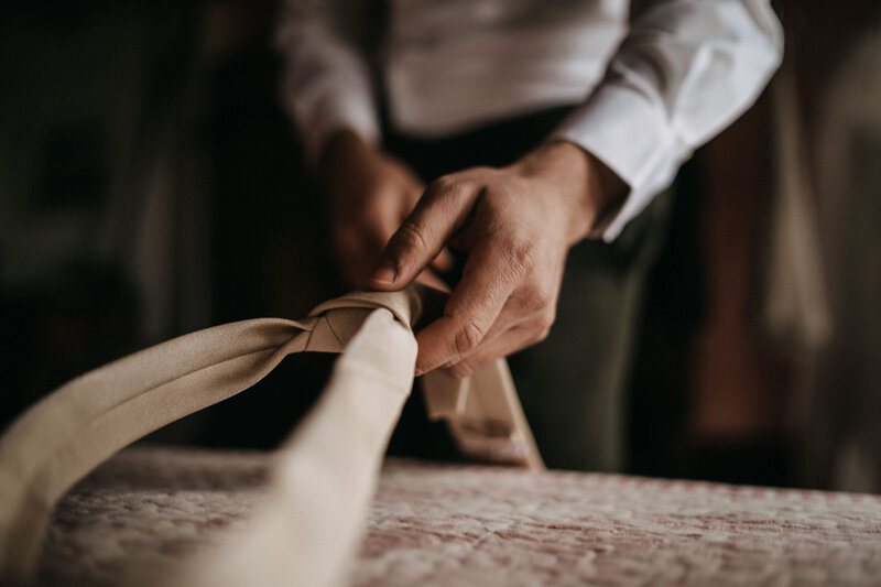 groom getting ready in tuscany for intimate wedding