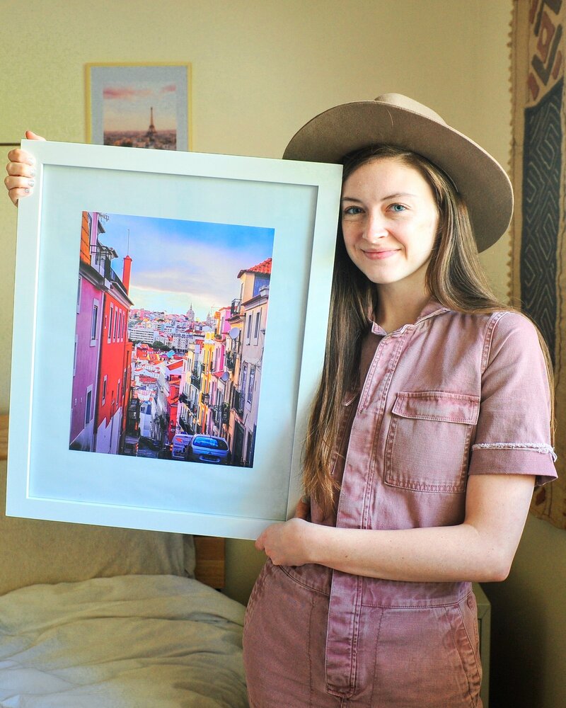 Kacy Beck photography holding a landscape fine art print for sale located in Gig harbor washington