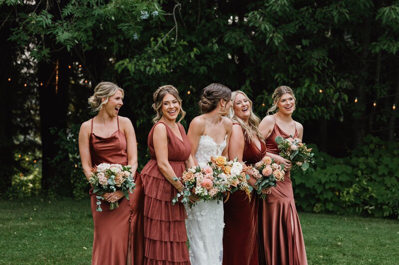 bride smiling with bridesmaids