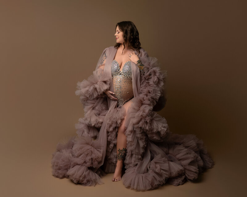 Maternity robe in mauve with voluminous ruffles and crystal embellishment – styled for editorial studio photo