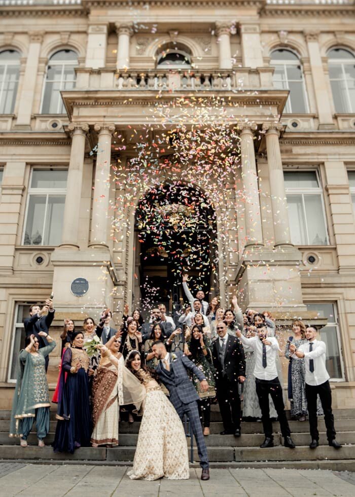 Yorkshire Wedding Photographer & Videographer capturing a joyful confetti throw outside the ceremony venue in Wakefield.