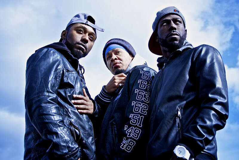 Trio Musician Portrait Black Lion Empire low angle perspective members standing against clouds in sky