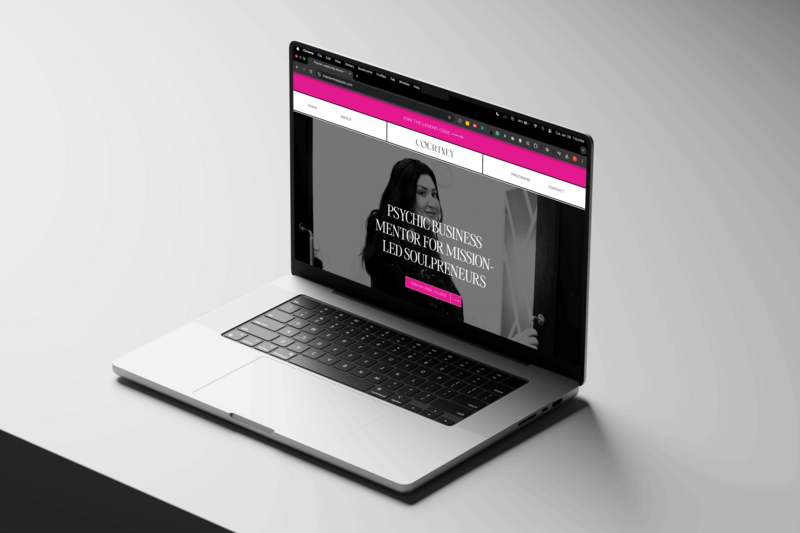 A sleek laptop with a pink and black design, highlighting a premium Showit website layout.