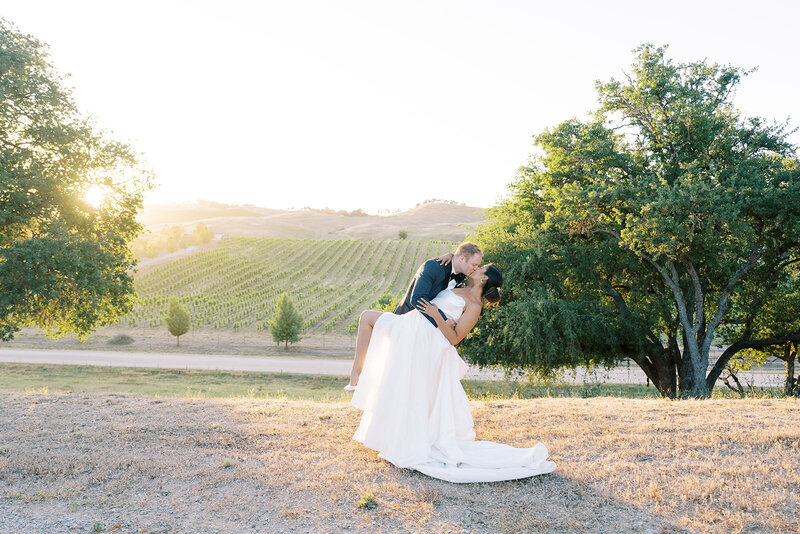 groom drips and kisses bride at Santa Barbara wedding