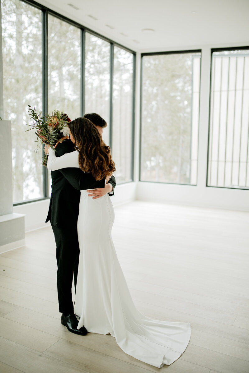 Bride and groom share an emotional first look during their Minneapolis modern wedding at Catalyst by NatureLink. 