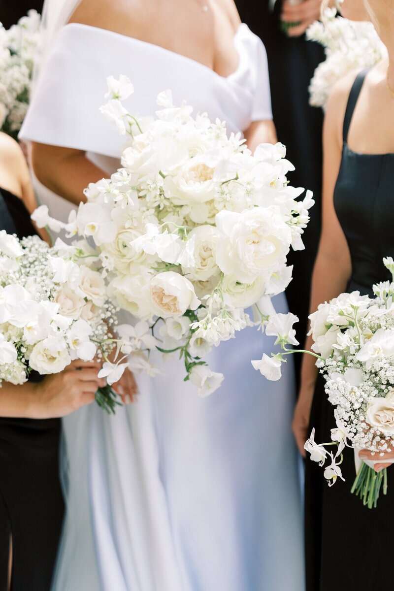 Joyful bride and bridesmaids smiling together, captured by one of the Milwaukee wedding photographers, Emily Barbara.