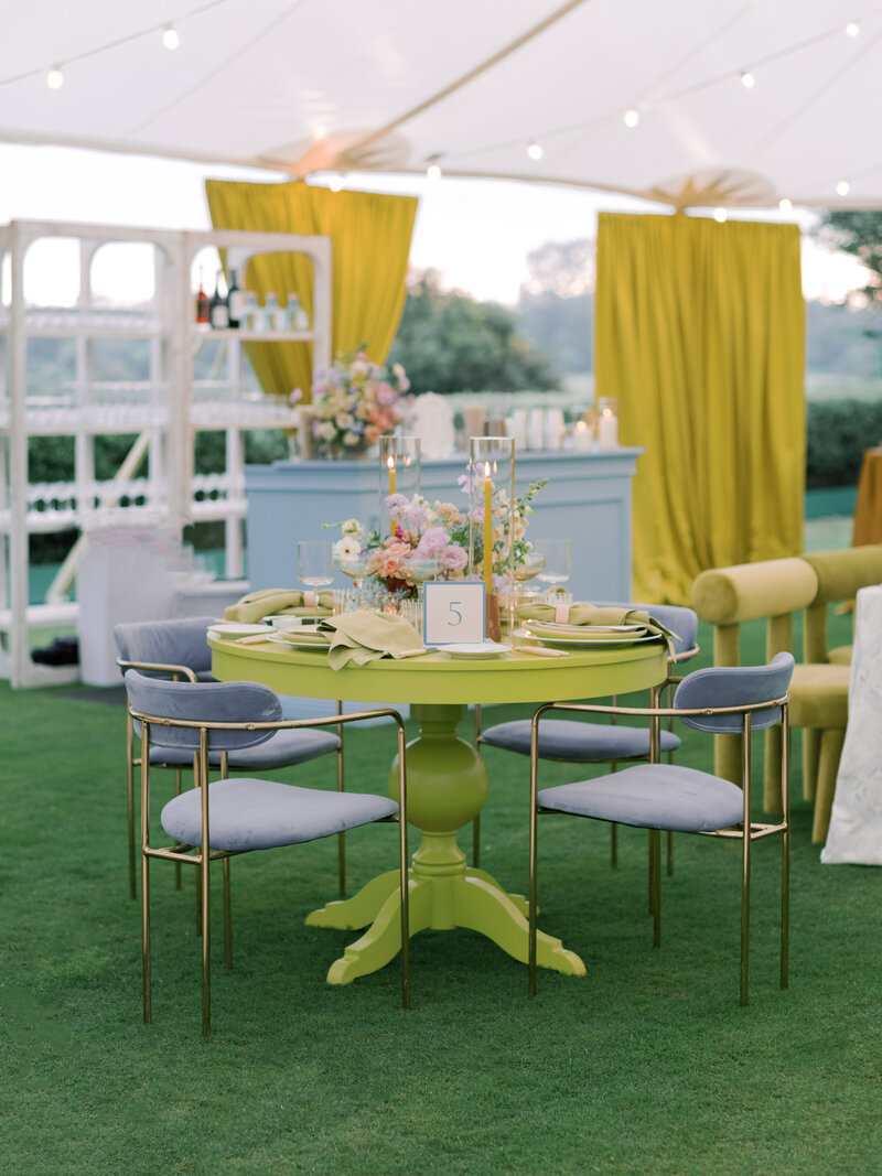 Our Conley Sofa, Conley Accent Chairs, and Huxton Chairs in Lime, set up outside on the grass overlooking the ocean