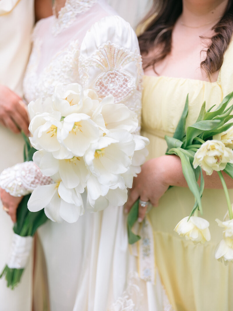 Girls in white and yellow dresses holding tulips