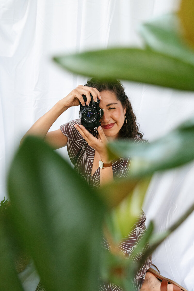 Victoria Barclay, photographer at Through Victoria's Lens, holding up her camera