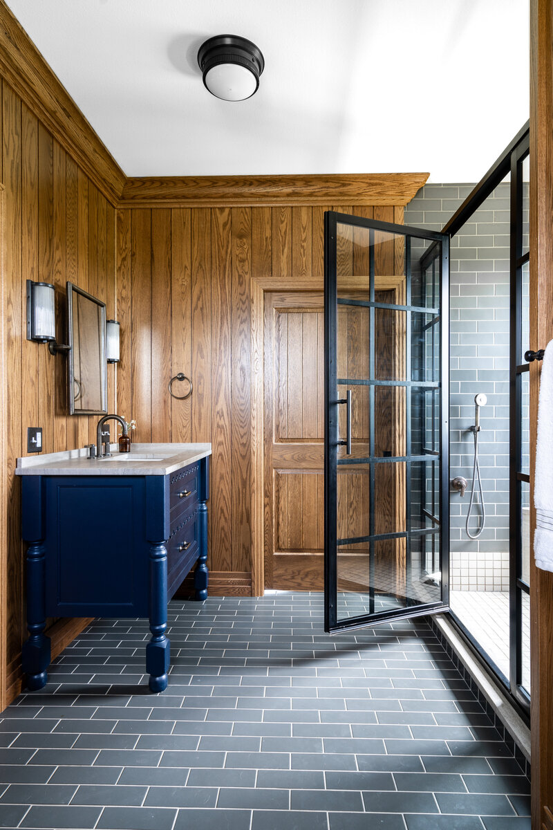 Modern wood paneling with blue vanity cabinet