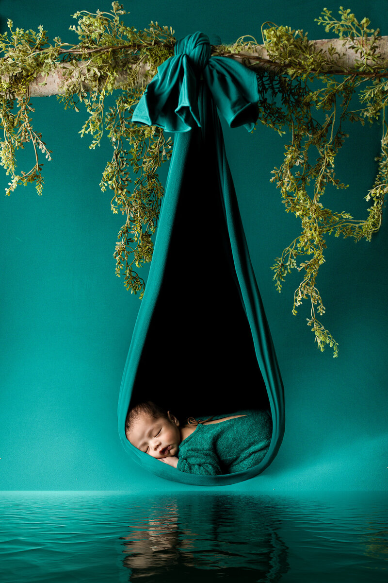 Newborn baby boy in a creative image during a newborn photo session in a Tucson studio