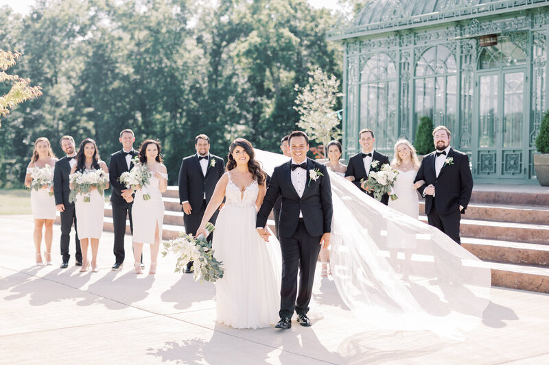 Bride and groom holding hands under umbrella at Silverbrook Farm captured by Virginia Wedding Photographer Sarah Botta Photography