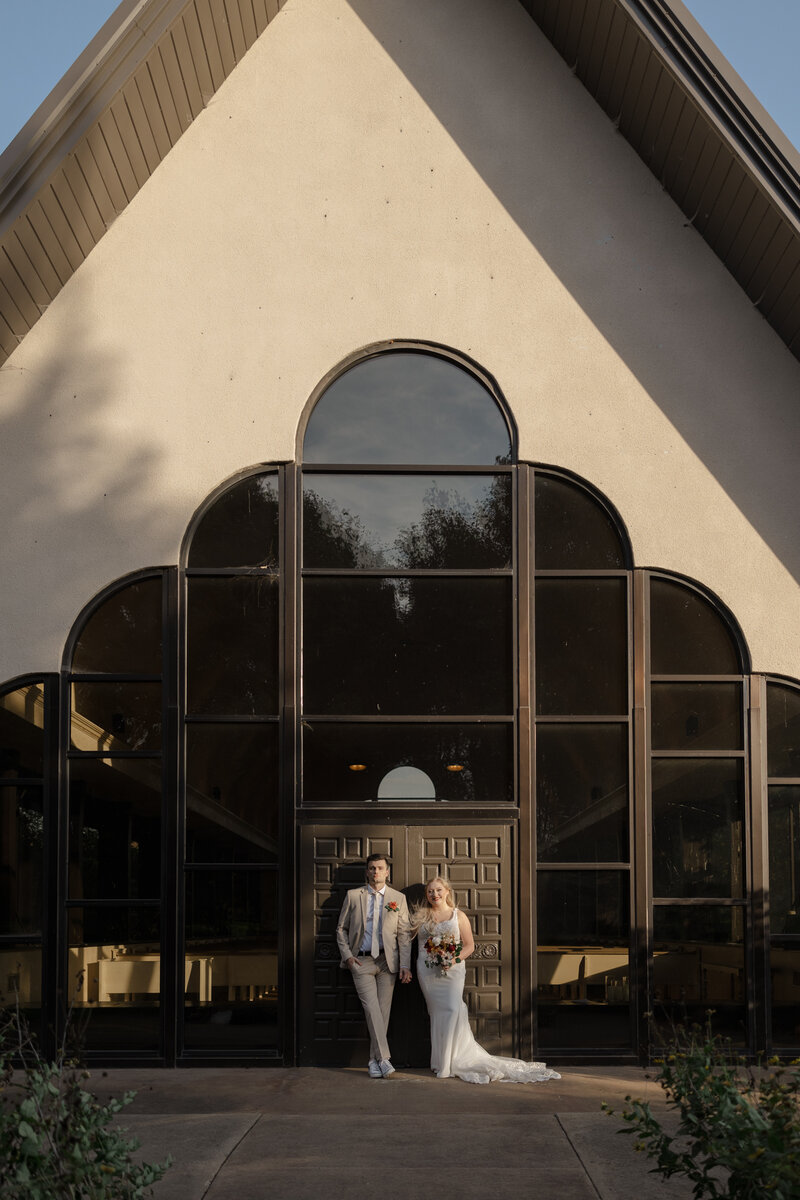 Editorial wedding photography of a couple outside a chapel photographed by Claire Katan.