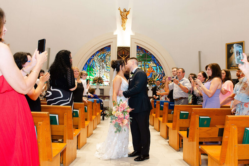 a bride and groom kiss during their church wedding.  Captured by Ottawa wedding photographer JEMMAN Photography