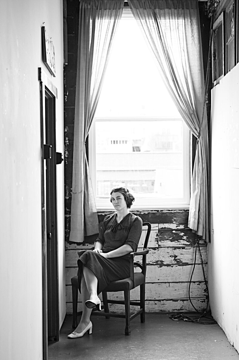 Black and white photo of a woman sitting in a chair