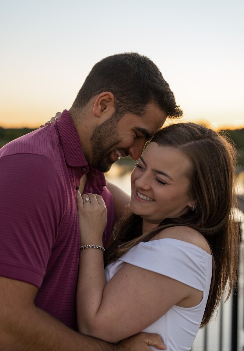 Couple touching foreheads and laughing at sunset during a Coxhall Gardens engagement session in Carmel