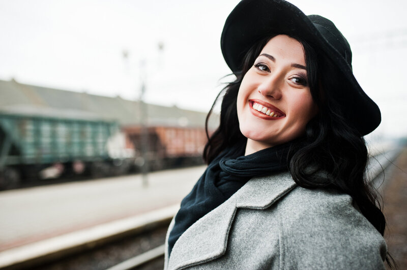 Headshot for author, Harlow Blackthorne, brunette girl wearing gray coat and black hat