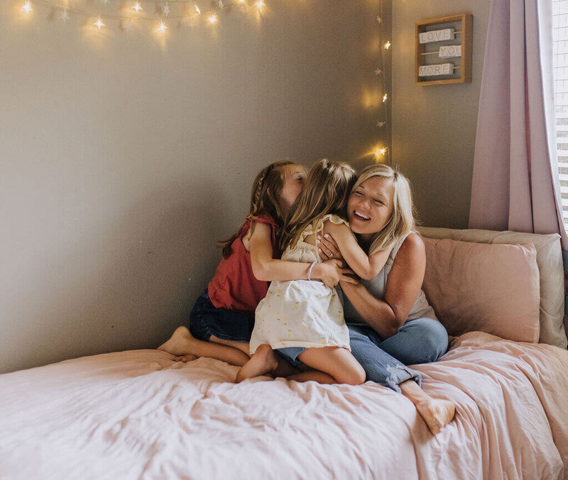mother hugging daughters