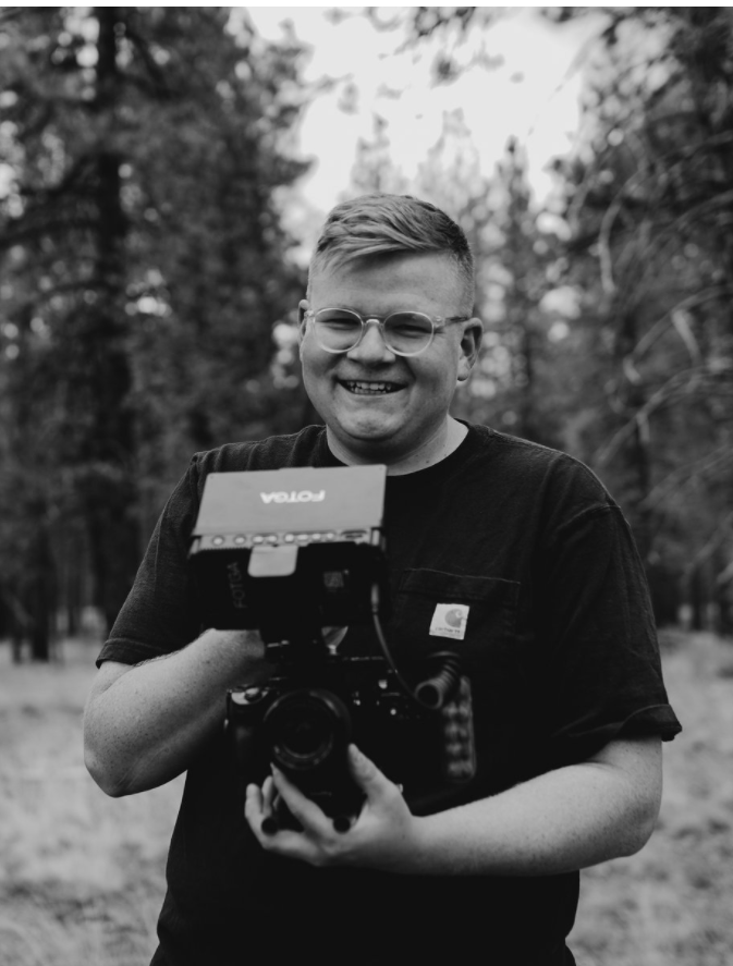 man smiling with camera