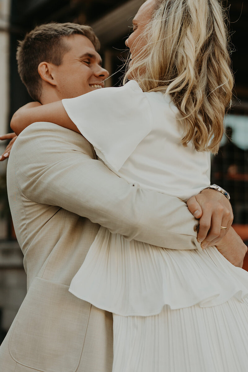 couple in tan and white at their rehearsal dinner