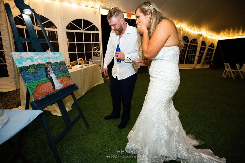 couple seeing their live event painting for the first time at their wedding