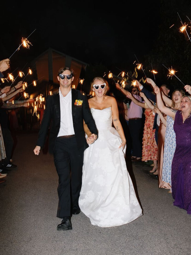 Couple walking down Raleigh wedding planned sparkler exit