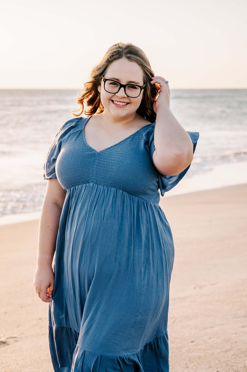 Haleigh in a blue dress on a beach near Orlando