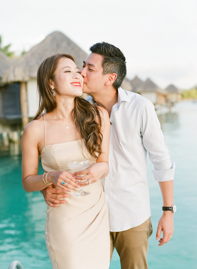 Couple smiling drinking champagne St Regis Bora Bora