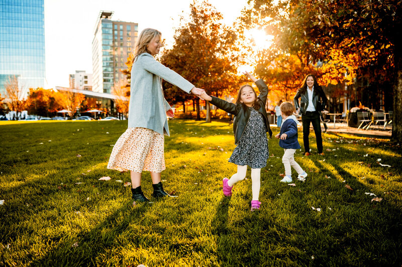 Girl dancing holding her mothers hand in Boston.