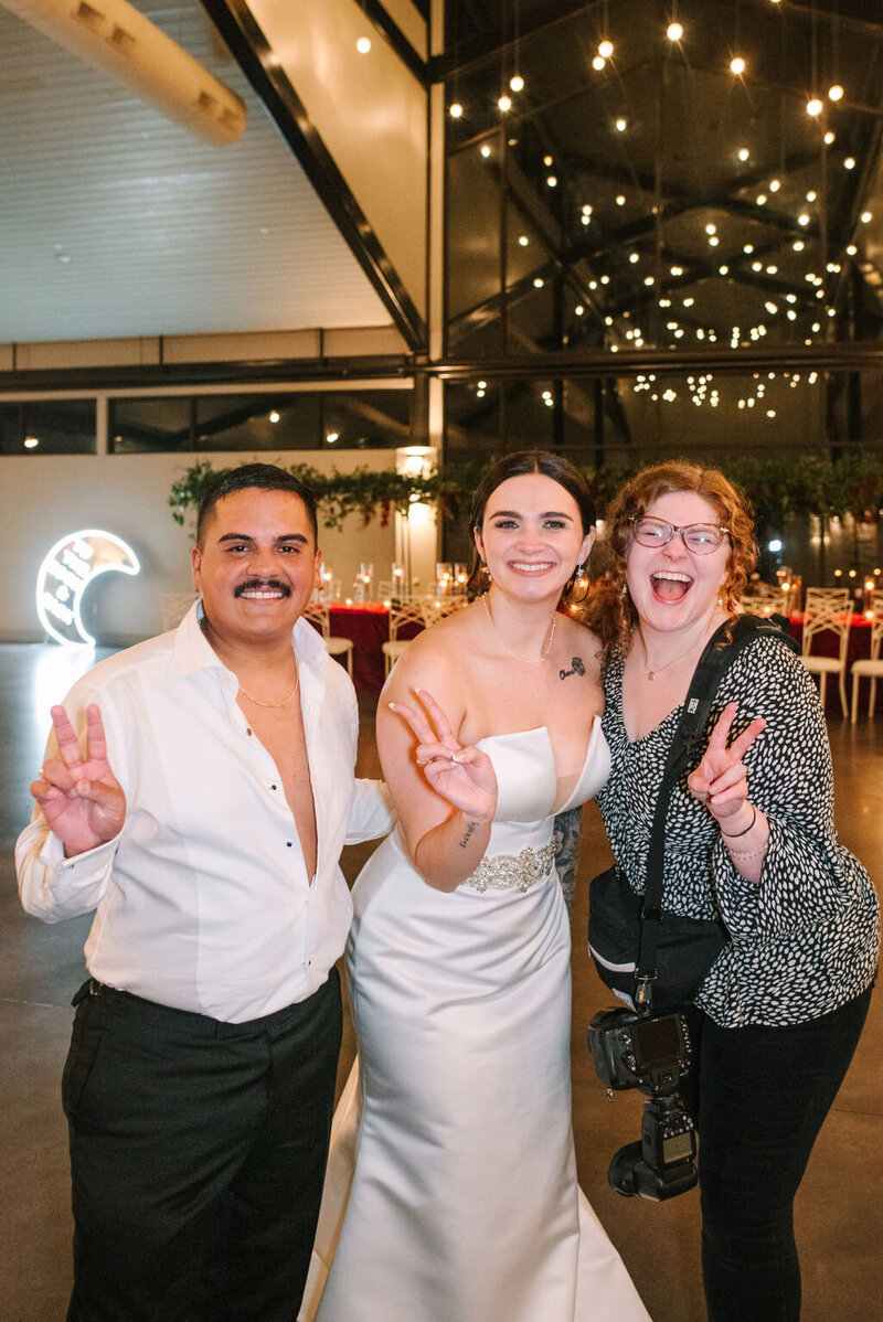 Allison Bolin Texas wedding photographer posing with a bride and groom at Dallas wedding reception