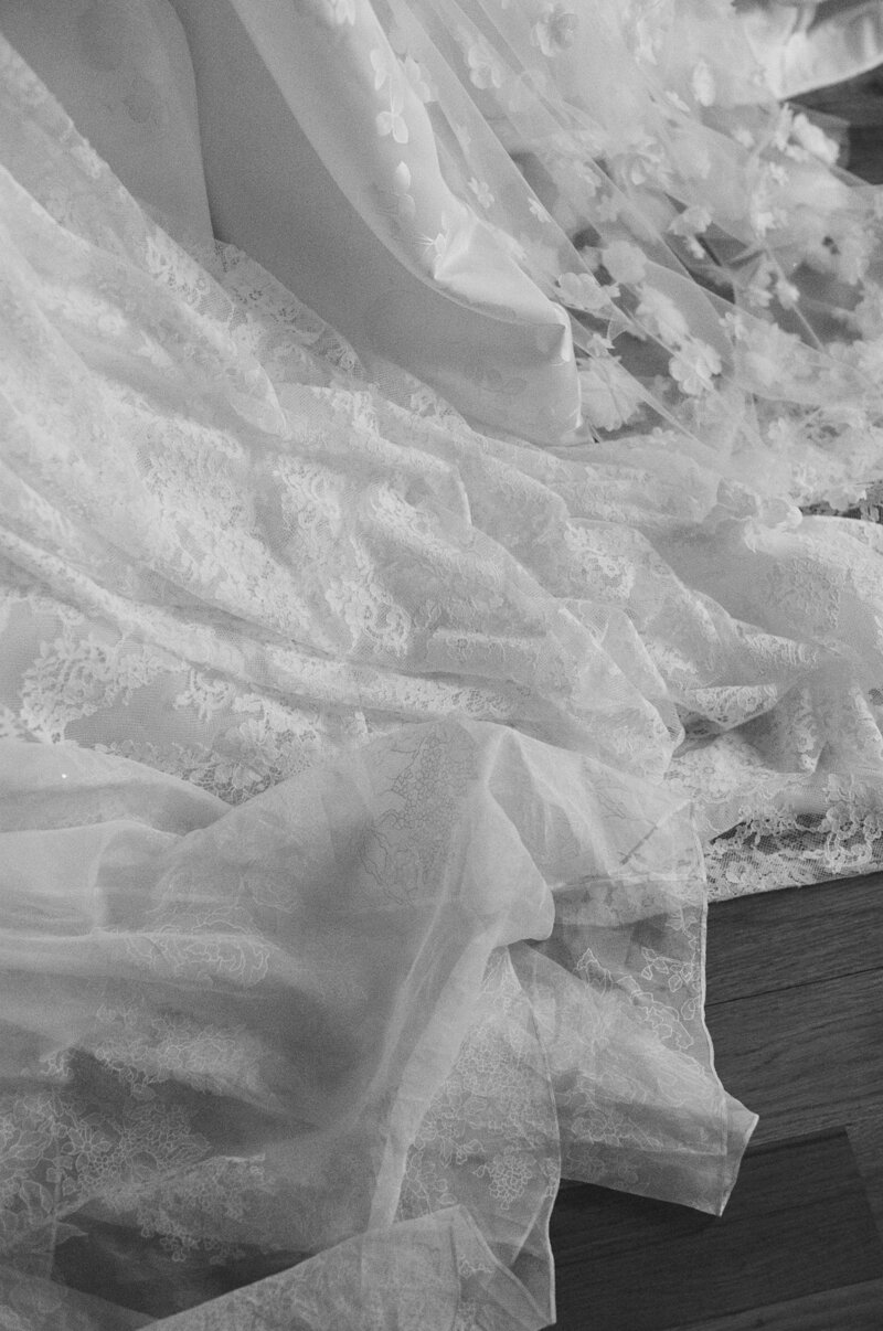 Wedding gown fabric with lace and tulle layers.