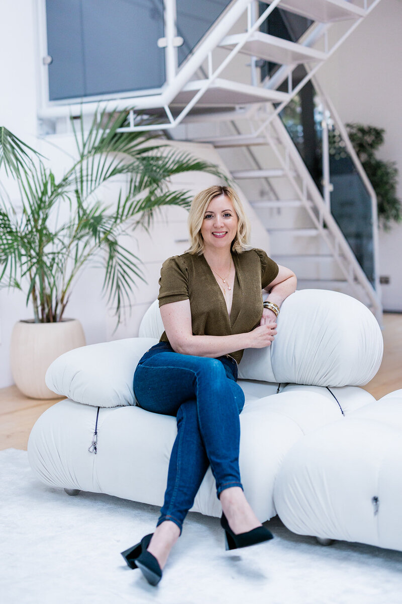 Nova Cobban, Psychologist specialising in generational divide at work sitting comfortably holding a coffee