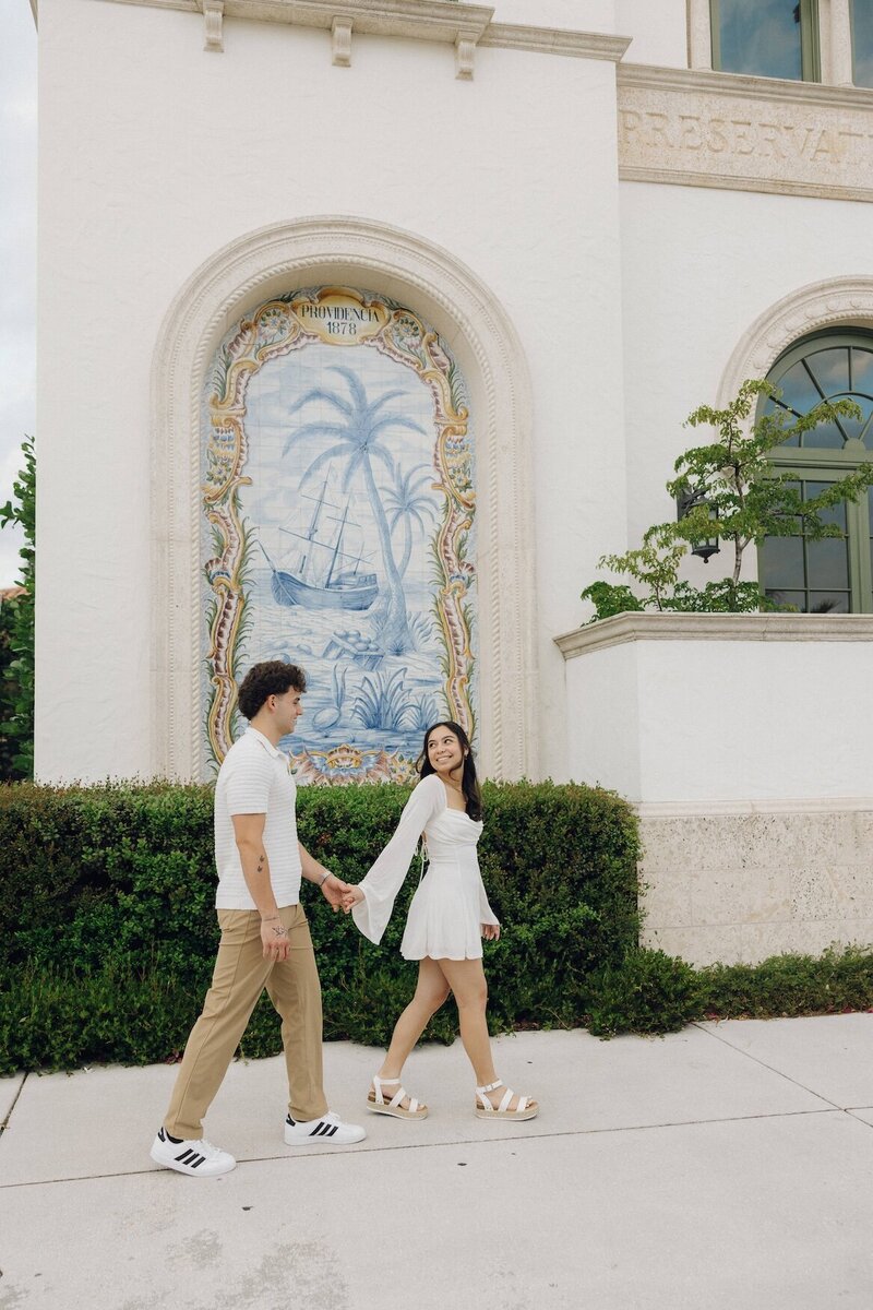 couple holds hands during photo session in south florida