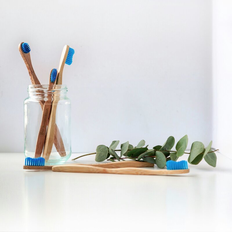 Wooden toothbrush with green leaves