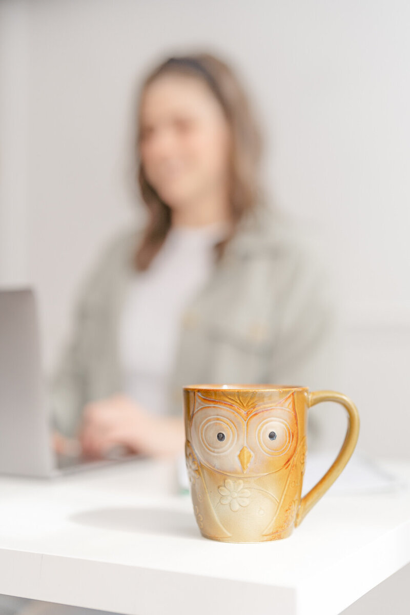 owl mug with woman working at the back by a branding photographer in Fairfax, VA