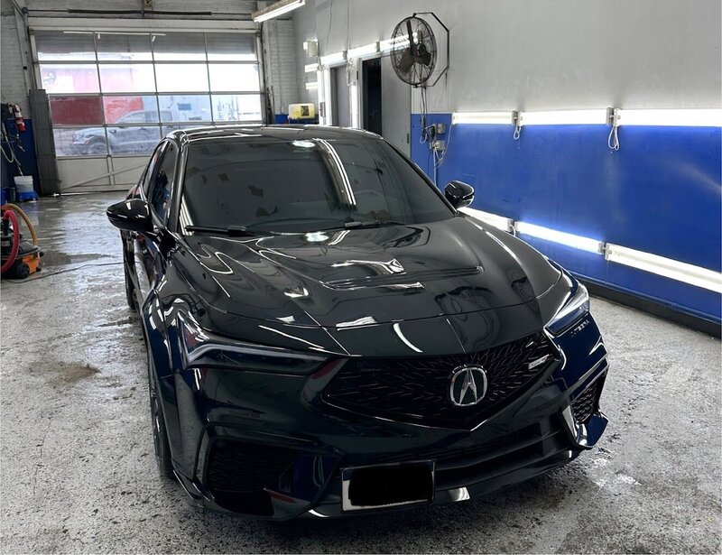 Black luxury car receiving a premium car wash at Superstar Auto Spa. This image showcases our thorough car wash services, including exterior cleaning, tire shine, and window cleaning for a showroom-ready finish.
