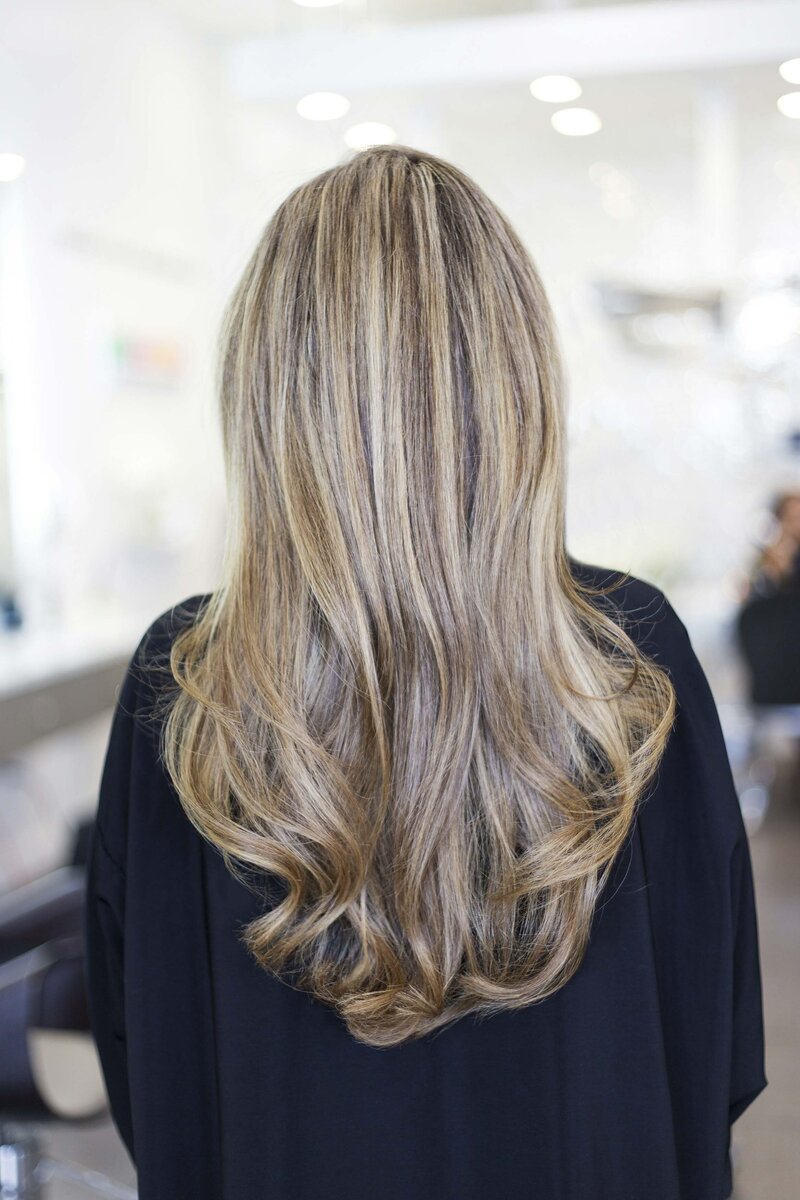 Back of blonde woman's hair in a salon
