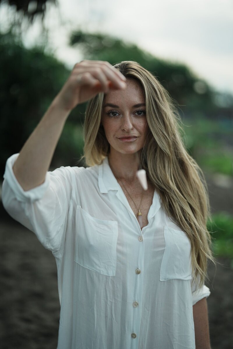 Noelle Rivet holding a dowsing crystal performing Hypnosis