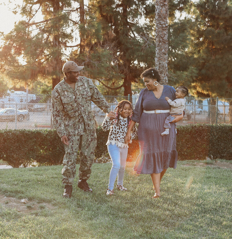 US Navy Sailor with family walking and holding hands