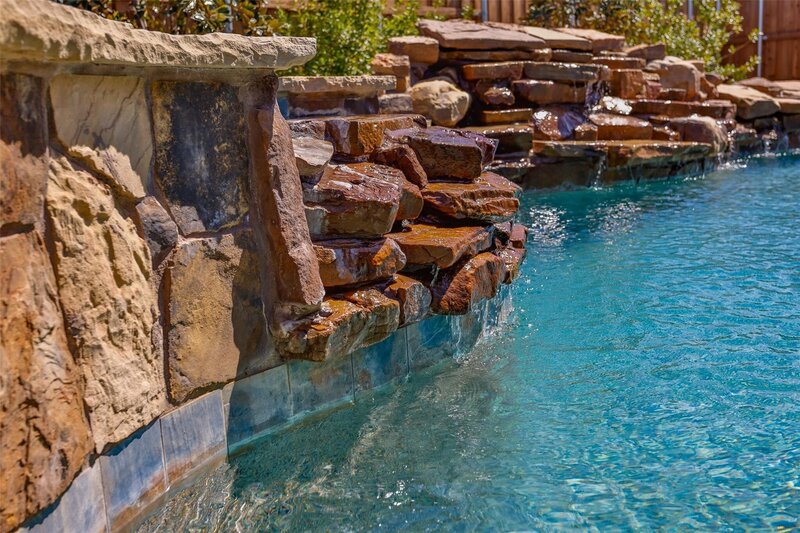 Sparkling waterfall pool and spa Krum Texas home for sale