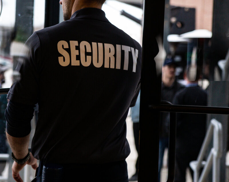 rear-view-of-a-security-guard-in-uniform-patrollin-2023-11-27-05-01-28-utc
