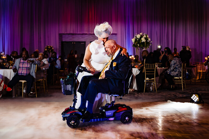 A bride and her handicap father dancing at the wedding reception