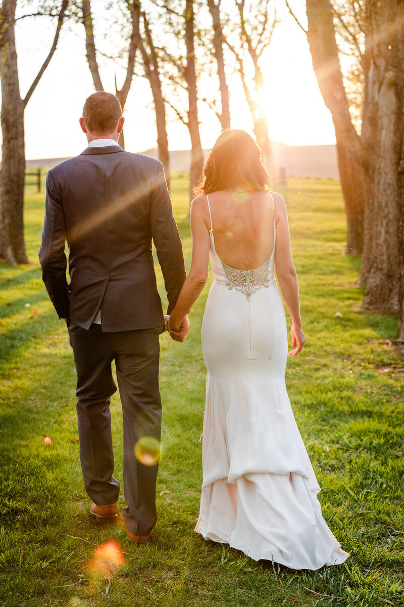 Bride and Groom walking into Sunset