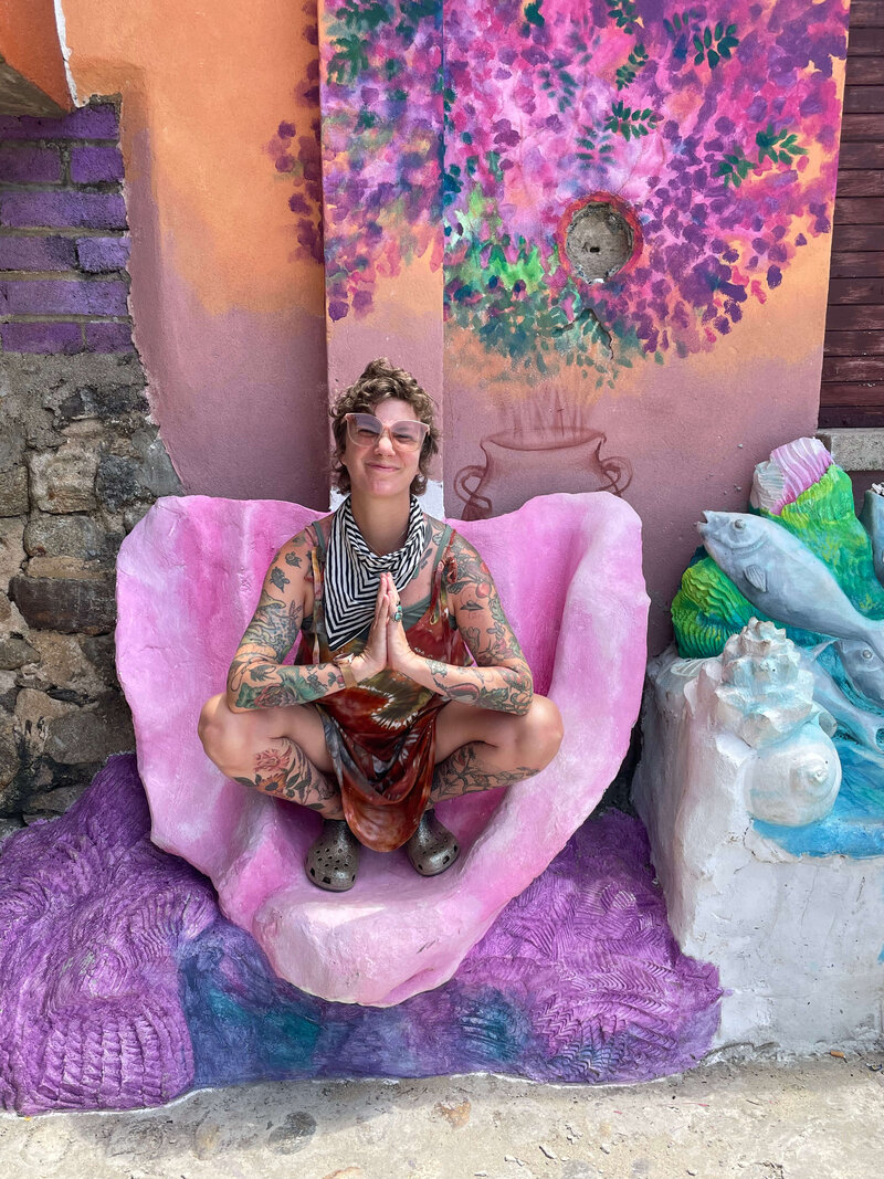 colorful yoga shape in front of mural
